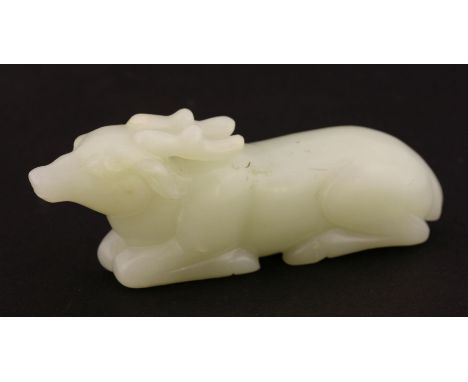 A jade Stag,20th century, the pale green stone carved as a recumbent, antlered beast,10.2cm二十世纪 白玉卧鹿把件