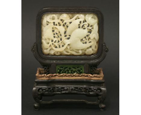 A deeply-carved jade Plaque,20th century, in Ming style and of rectangular form with an egret flying amongst pierced and carv