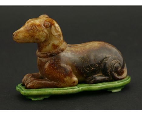 A jade Hound,20th century, the russet and brown stone well carved with a braided collar, 10cm, green stand二十世纪 青褐玉狗把件