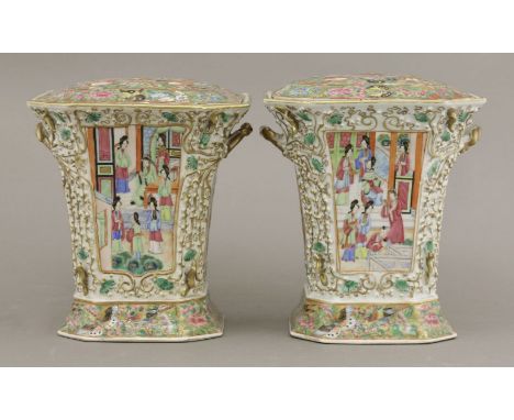 A pair of Canton enamel Bough Pots and Covers,c.1860, the panels of figures in interiors and in a courtyard, with applied fru