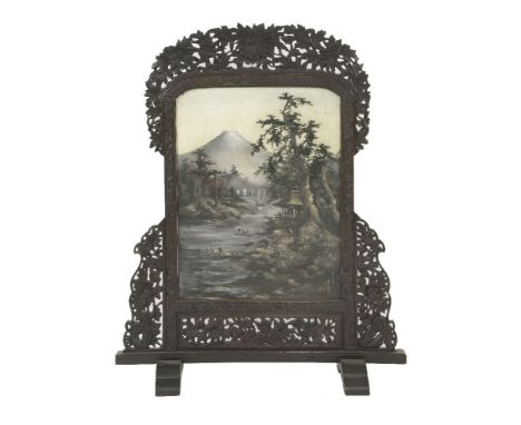 A fire screen, 1930s, oil painted with thick impasto, with boats on a river under Mount Fuji, the hardwood border carved and 