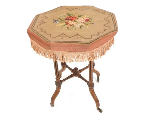 A Victorian mahogany and light oak octagonal topped side table, made up, with a tapestry floral cover, on X splayed base with