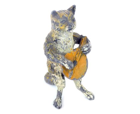 An early 20thC cold painted lead figure of a cat, modelled standing playing a lute, 8cm high. (AF) 