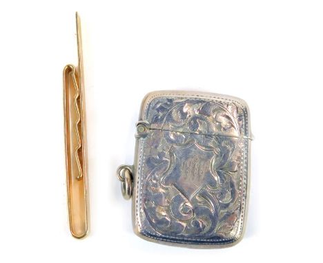 A 9ct gold tie clip, with engine turned cross hatched decoration, 6g, and a silver match case, with foliate scroll decoration