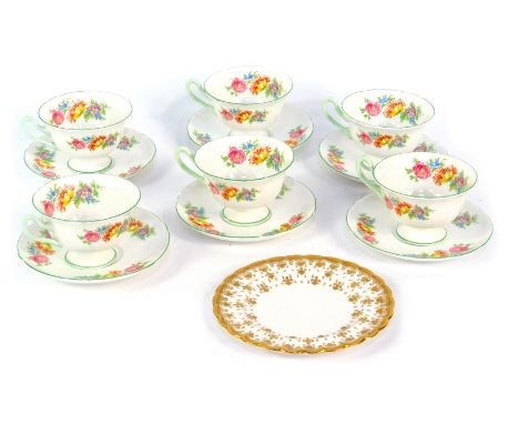 A set of six Shelley cups and saucers, each with a floral pattern and green border, and a Spode side plate with gilt decorati