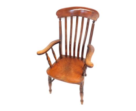 A Victorian elm and mahogany lath back kitchen chair, with solid saddle seat, raised on turned legs, united by a double H fra