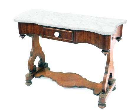 A Victorian mahogany marble top washstand, the shaped top above a single drawer, with lower shelf, on scroll supports with bu