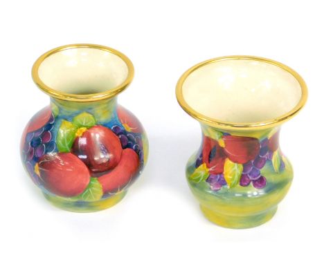 A Moorcroft Pottery miniature enamel Pomegranate pattern vase, 4.5cm high, and a further miniature enamel vase, 5cm high, bot