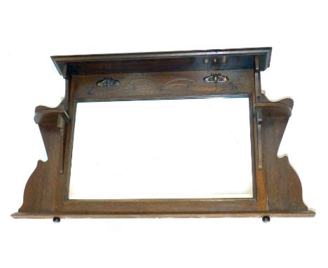 An Art Nouveau oak framed overmantel mirror, with shelf section and copper detail, 71cm high, 102cm wide, 16cm deep.