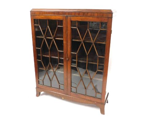 An Edwardian mahogany display cabinet, with two astragal glazed doors, and a fitted three shelf interior, on bracket feet, 14