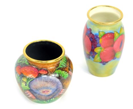 A Moorcroft Pottery miniature enamel vase decorated in the Pomegranate pattern, 6cm high, and a further miniature enamel vase