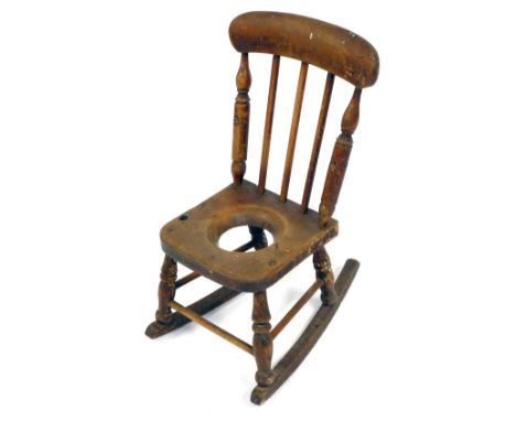 A Victorian child's oak and beech ladder back commode rocking chair, 65cm high. (AF) 