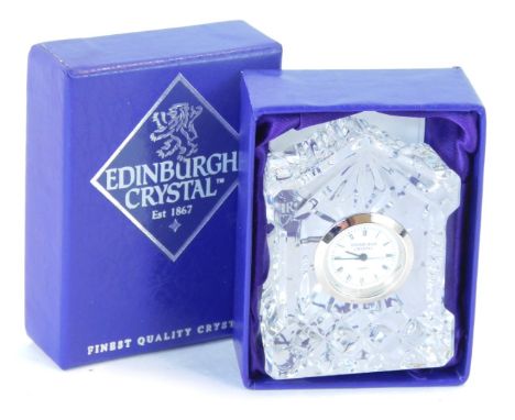 An Edinburgh Crystal miniature clock, circular white dial bearing Roman numerals, quartz movement, the case of architectural 