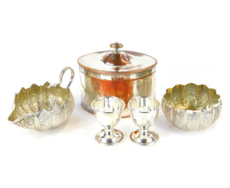A late 19thC Indian cream jug, embossed with panels of flowers, with serpent handle, together with a sugar bowl of fluted for
