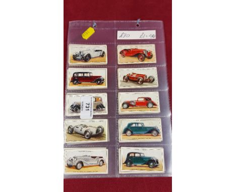 A collection of Player's cigarette cards depicting vintage cars