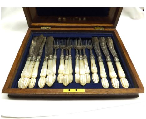 A Victorian Walnut and Oak Cased Set of mother-of-pearl handled and Silver-bladed Fish Knives and Forks, hallmarked Sheffield