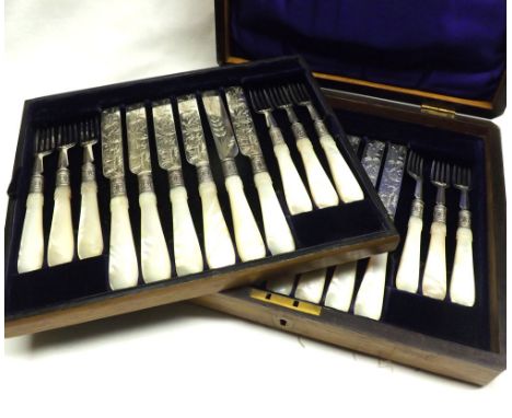 A Victorian Oak Cased Set of twelve mother-of-pearl handled Dessert Knives and Forks with silver blades, hallmarked Sheffield