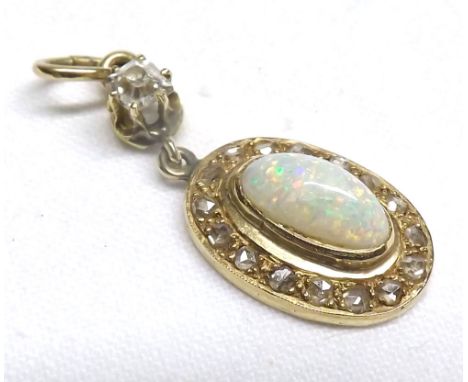 A high grade yellow metal oval Pendant with centre domed oval Opal measuring approximately 9mm x 5mm, small Rose Cut Diamonds