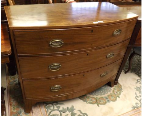 A 19th Century Mahogany and line inlaid bow front Chest of three long drawers, fitted with oval Brass and swan neck handles, 