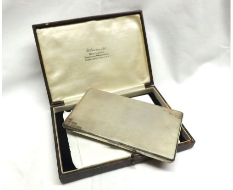 A George V Silver Cigarette Case in the Art Deco manner, the body with engine-turned decoration, hallmarked London 1935, in a