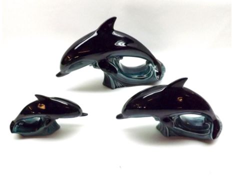 A Graduated Set of Three Poole Pottery Dolphins, largest 9  wide 