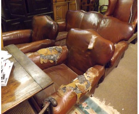 Late 19th Century three-piece suite, decorated with foliage carved frame and short legs, currently upholstered in brown leath