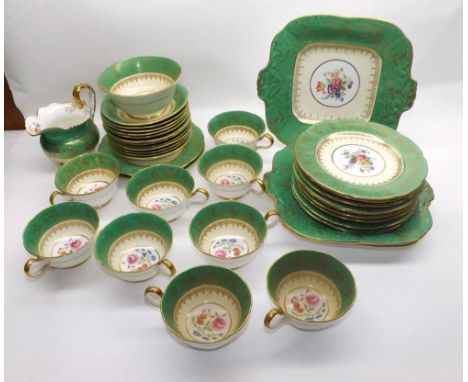 An Aynsley part Tea Service decorated with floral centres to a green and gilt highlighted background, comprising: Jug, two Sa