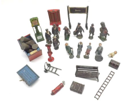 A small collection of O gauge railway accessories to include luggage, parcel scales, signs, trolleys, passenger and personnel