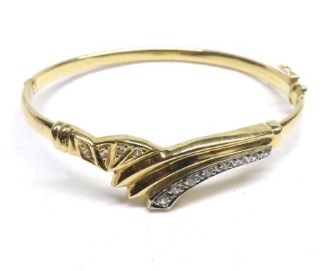 High grade yellow metal hollow bangle in  Art Deco style with curved front panel set with white stones stamped  18C  weighing