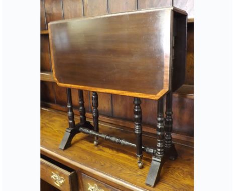 Late 19th Century Mahogany Sutherland table with central inlaid detail, raised on a turned ebonised frame, with Brass and Cer