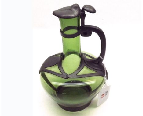 Late 19th Century small green glass and pewter mounted Decanter, fitted with hinged lid, looped handle, crown mark to base an