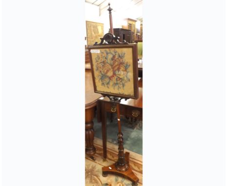 A 19th Century Rosewood Pole Screen with floral embroidered central panel, plain shaft terminating in a ring turned support, 