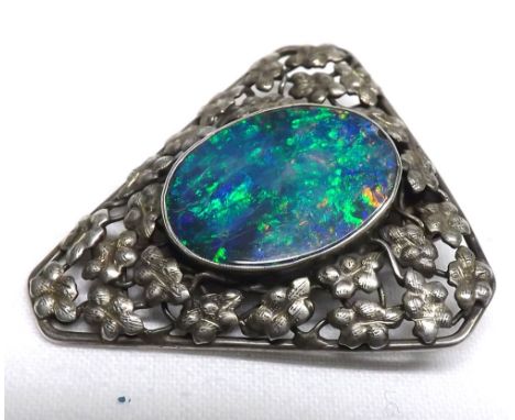 Small Opal and white metal clip-on Brooch of triangular form, pierced frame, foliate detail, 1 =  long 