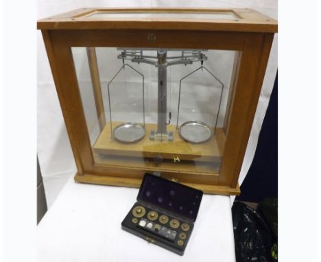 A cased set of Philip Harris Birmingham Chemists Beam Scales, the oak case with rise and fall door, 18  wide 