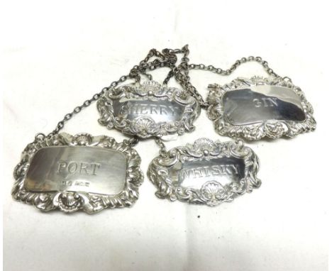 A collection of four Queen Elizabeth II Silver Decanter Labels, marked  Port ,  Sherry ,  Gin  and Whiskey , all bearing Birm
