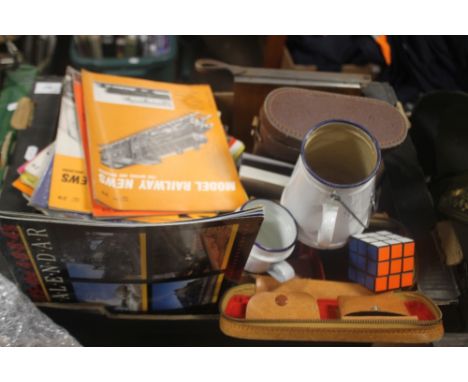 A TRAY OF MODEL RAILWAY NEWS MAGAZINES TOGETHER WITH CASED TELSTAR BINOCULARS, ENAMEL MUGS ETC