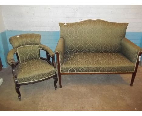 AN EDWARDIAN TWO PIECE SUITE TO INCLUDE A TWO SEATER SOFA AND A BOWED CHAIR