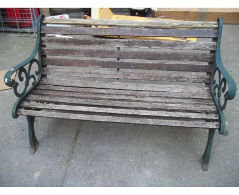 A CAST IRON AND WOOD GARDEN BENCH