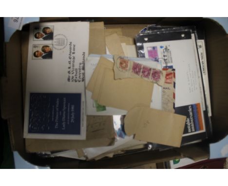 A TRAY CONTAINING FIRST DAY COVERS AND LOOSE STAMPS