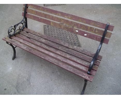 A CAST IRON AND WOODEN GARDEN BENCH