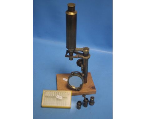 A VINTAGE BRASS MICROSCOPE WITH ASSORTED SLIDES AND ADDITIONAL LENSES