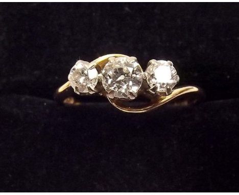 An 18ct gold three stone diamond crossover ring 