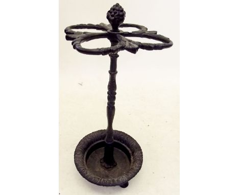 A Victorian cast iron four section stick stand with fruit finial 