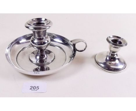 A silver scroll candlestick and a silver plated chamber stick 