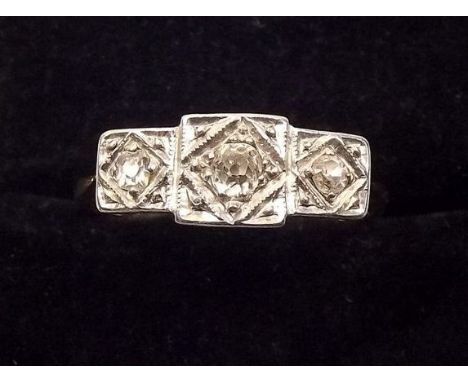 An 18ct gold and platinum three stone illusion set diamond ring 