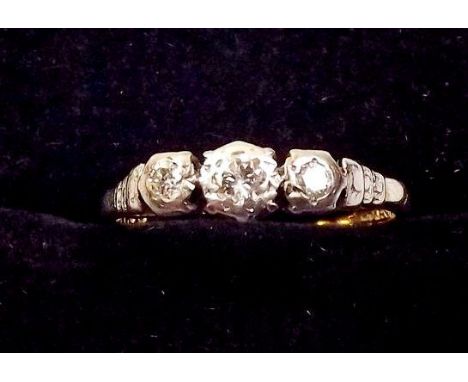 An 18ct gold platinum three stone diamond ring 