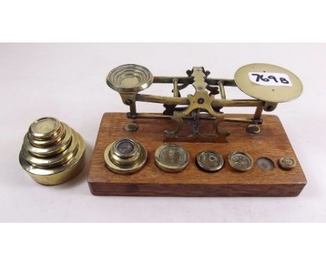 A set of brass postal scales and weights plus a set of 1oz to 1 lb weights 