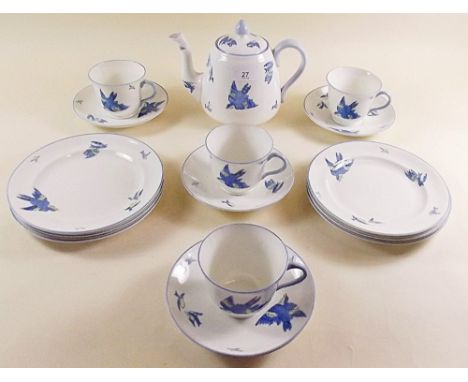 A Heathcote 'Williamsons Blue Bird' part tea service comprising: teapot, six tea plates, four cups and six saucers 