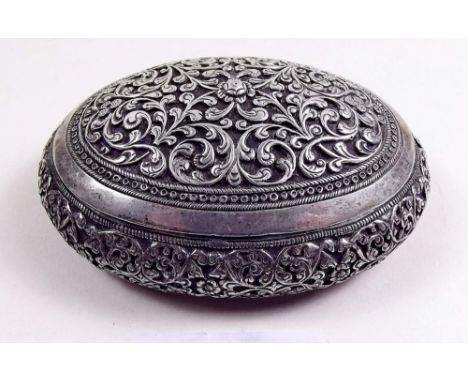 An Indian white metal oval snuff box with all over decoration 8.5cm x 6.5cm