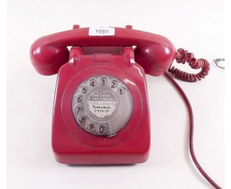 A vintage red dial telephone